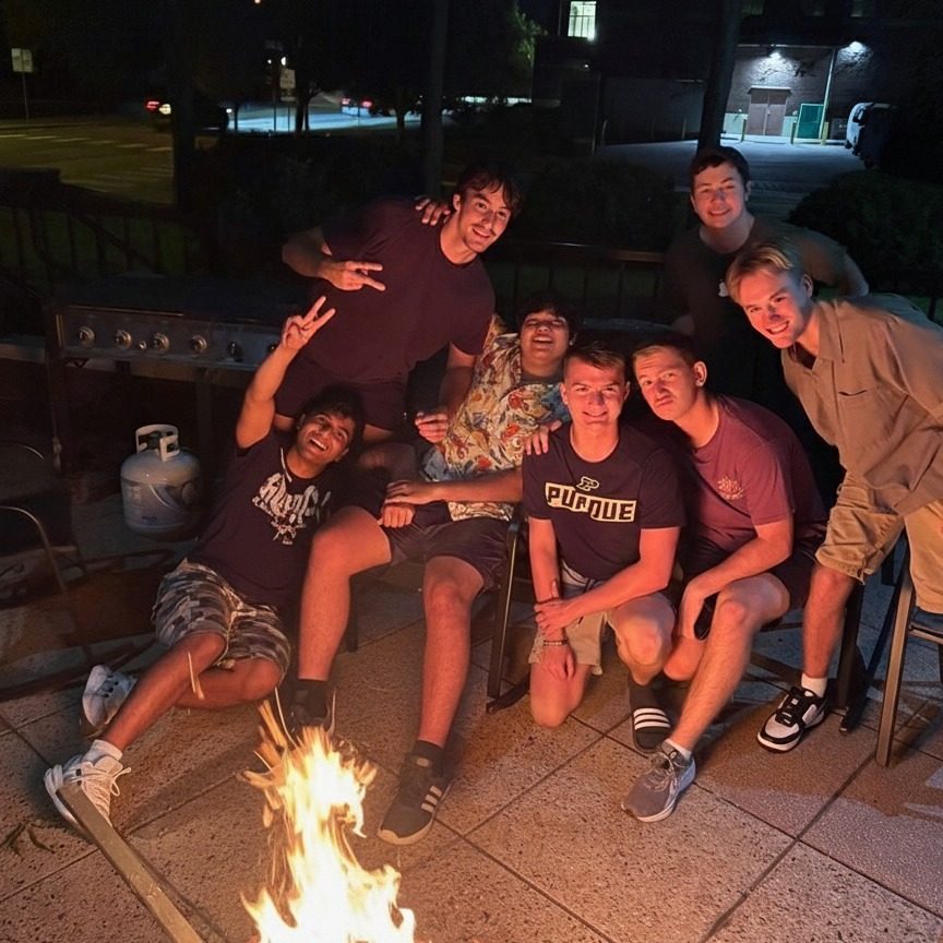 PNMs and brothers hanging out around the fire pit