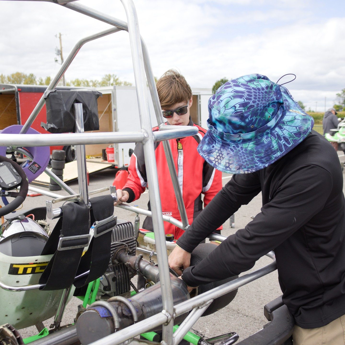 Triangle brothers working hands-on on the Grand Prix kart engine