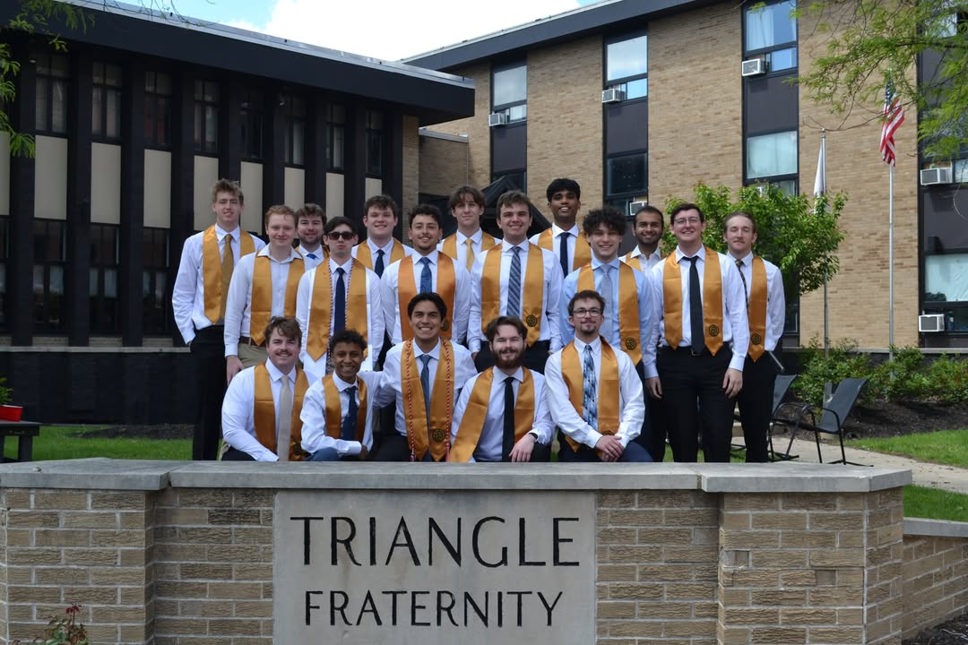 Triangle seniors at the chapter house sign on graduation day